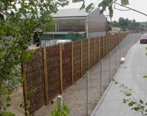 Non acoustic Green Barrier woven willow on industrial site.